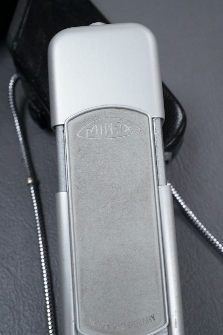 A Minolta Minox miniature camera Model B, in its original leather case with metal lanyard.